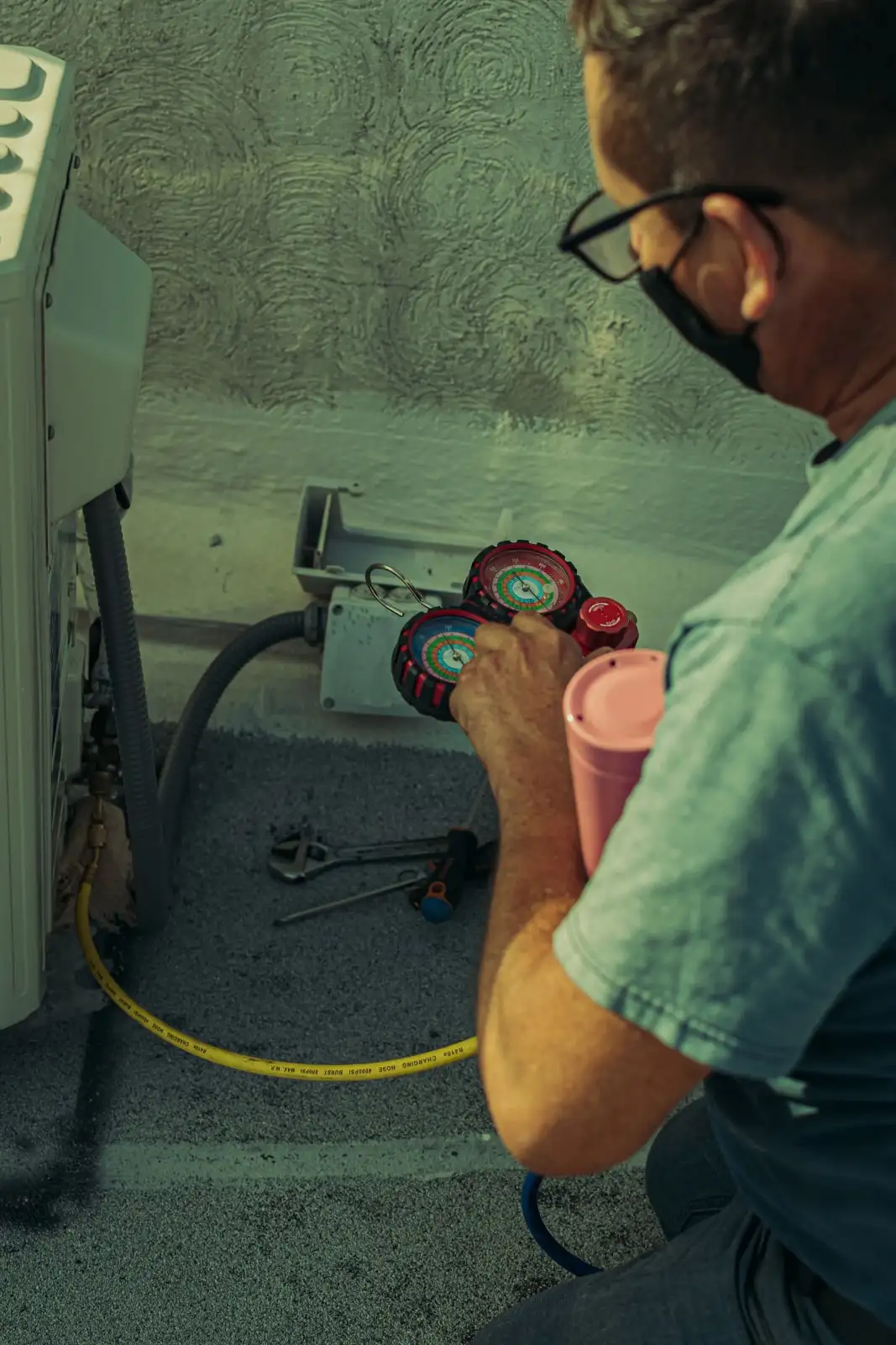Technician inspecting HVAC duct connections beneath a St. George home.