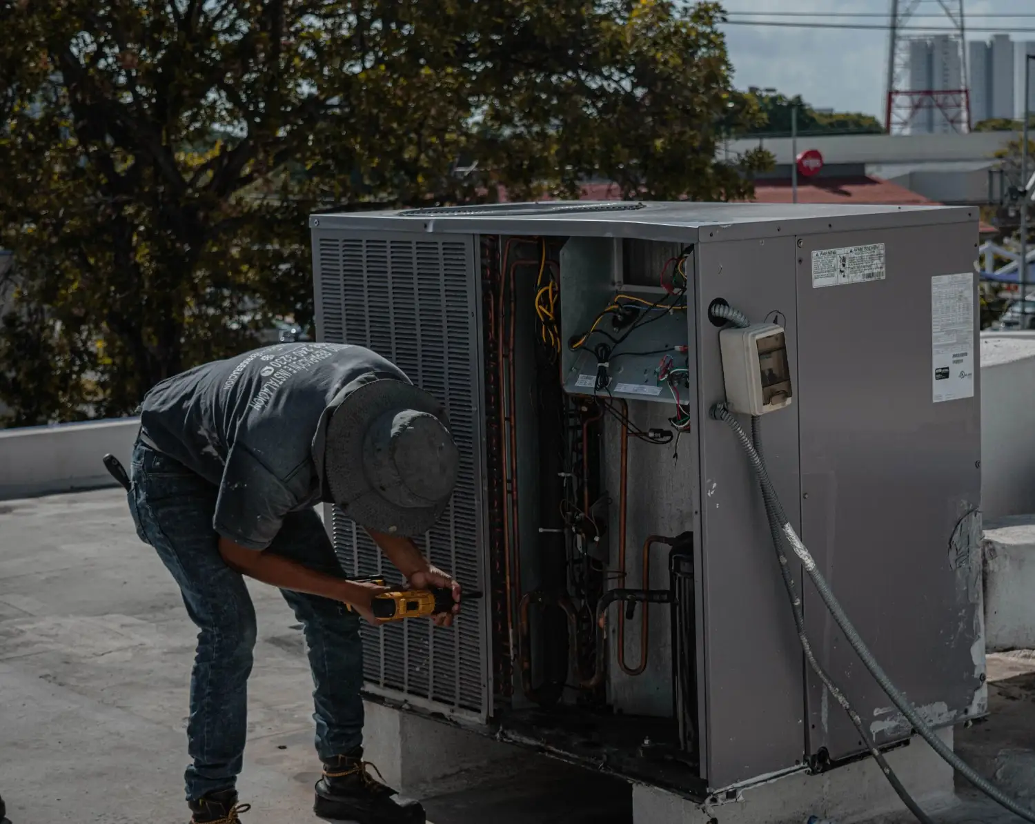 Technician showing HVAC system readings to a property owner in West Ashley, SC. HVAC Contractor near me